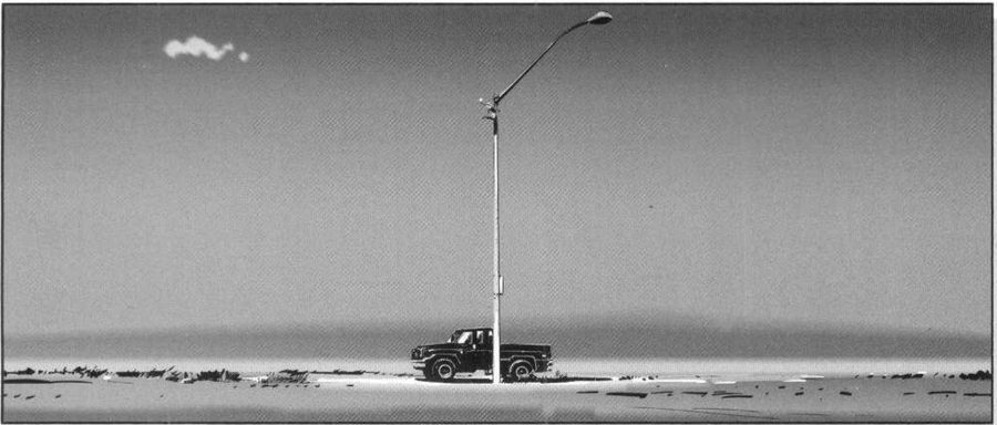 A pickup truck under a single tall street lamp on an empty horizon, lots of sky.