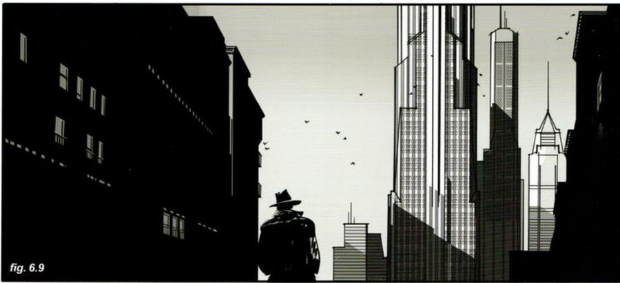 A man in a hat between dark buildings at the sides, tall towers in the light behind.