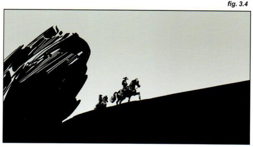A wide frame: the huge black rock at left, two riders climbing a long dark slope towards open pale sky at right.