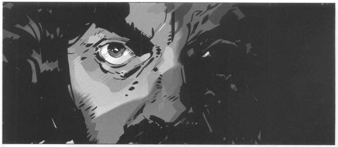 An extreme close-up of a man's face, one wide lit eye at upper left, the rest of the frame falling into black.